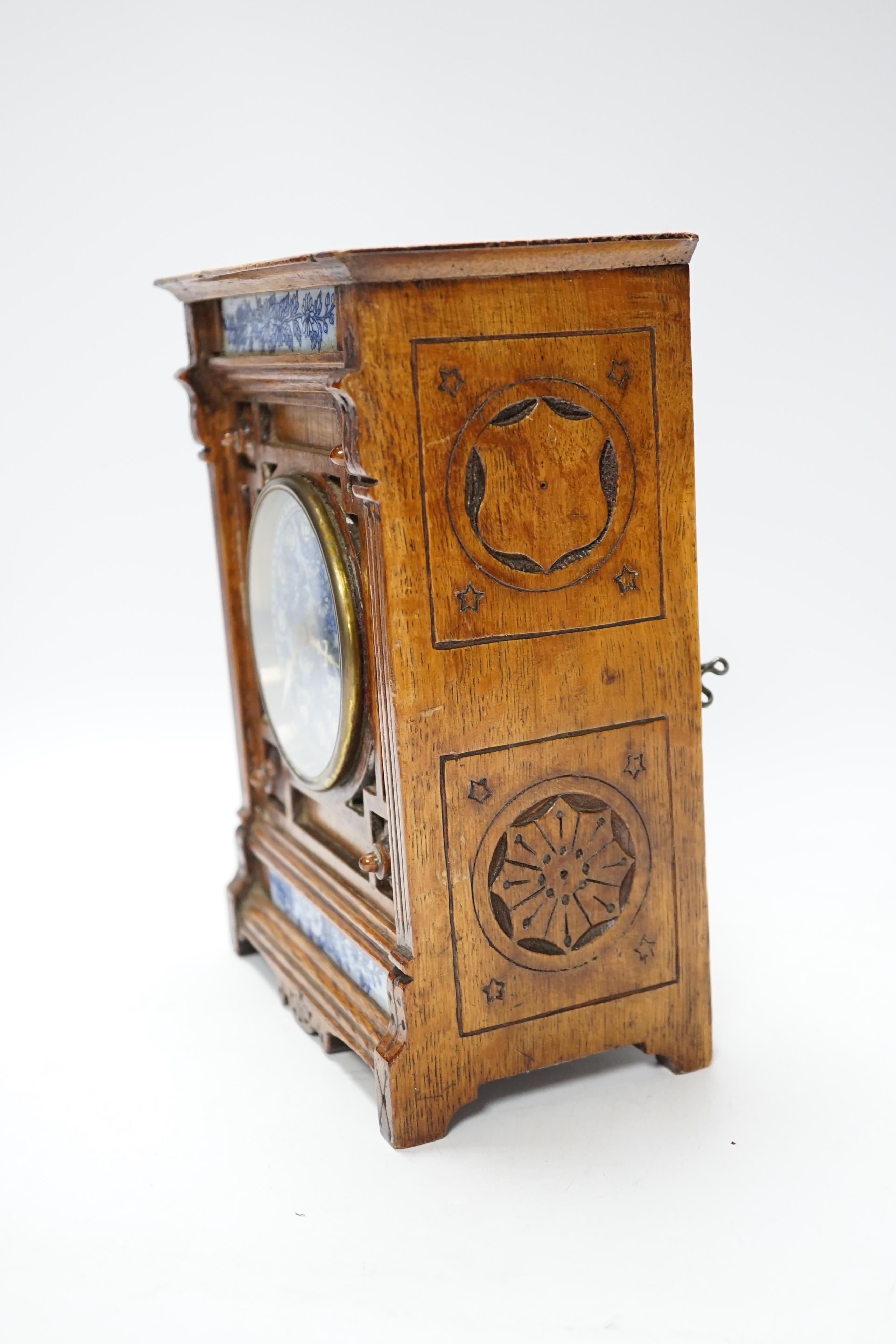A Victorian carved oak aesthetic mantel clock, 24cm high